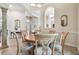 Elegant dining room with tile flooring, decorative columns, and arched entryways, showcasing sophisticated architectural details at 9611 125Th N St, Seminole, FL 33772