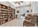 Inviting library with built-in bookshelves, cozy armchairs, and office view at 9611 125Th N St, Seminole, FL 33772