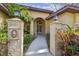 Charming front entrance with stone pillars, manicured landscaping, and decorative lanterns at 9611 125Th N St, Seminole, FL 33772