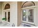 Close-up of a beautiful front entrance with decorative glass doors at 9611 125Th N St, Seminole, FL 33772