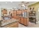 Large kitchen with a center island, stainless steel appliances, wood cabinetry, and granite countertops at 9611 125Th N St, Seminole, FL 33772