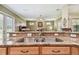 Kitchen with double sink, granite countertops, wood cabinets, and an open view to the living room at 9611 125Th N St, Seminole, FL 33772
