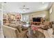 Open-concept living room with comfortable sofas, a TV, and seamless flow to the kitchen area at 9611 125Th N St, Seminole, FL 33772