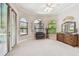 Bright main bedroom featuring arched windows, neutral carpet, and backyard views at 9611 125Th N St, Seminole, FL 33772