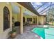 Covered outdoor patio with tile flooring, ceiling fans, outdoor furniture and a view of the pool at 9611 125Th N St, Seminole, FL 33772