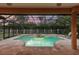 Screened pool area with spa, pavers, lounge chairs, and a backyard privacy fence at 9611 125Th N St, Seminole, FL 33772