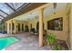 Screened lanai with covered patio, outdoor dining set, tile flooring and access to pool and spa at 9611 125Th N St, Seminole, FL 33772