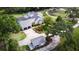 An aerial view of a beautiful home with mature trees, a pool, and long driveway at 10101 Bryant Rd, Lithia, FL 33547