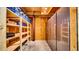Spacious unfinished basement with shelving and large refrigerator for extra storage at 10101 Bryant Rd, Lithia, FL 33547