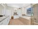 Luxurious bathroom featuring a soaking tub, a separate shower, and dual vanities with granite countertops at 10101 Bryant Rd, Lithia, FL 33547