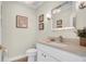 Neat half bathroom features stylish mirror, sink, toilet, and tasteful decor at 10101 Bryant Rd, Lithia, FL 33547