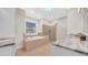 Luxurious bathroom with a soaking tub, walk-in shower, and marble countertops at 10101 Bryant Rd, Lithia, FL 33547