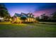Exterior of home with a metal roof, large lawn, and well-kept landscaping at 10101 Bryant Rd, Lithia, FL 33547