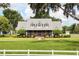 Charming single-Gathering home with a lush green lawn, mature trees, and a metal roof in a peaceful setting at 10101 Bryant Rd, Lithia, FL 33547