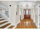 Elegant foyer featuring hardwood floors, staircase, chandelier, and a view of the front door at 10101 Bryant Rd, Lithia, FL 33547