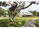 Charming home with a well-manicured lawn, mature trees, and a circular driveway at 10101 Bryant Rd, Lithia, FL 33547