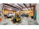 Large garage space with cars, mower, tools and a high ceiling at 10101 Bryant Rd, Lithia, FL 33547