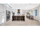 Modern kitchen with stainless steel appliances, white cabinetry, a large island, and adjacent breakfast area at 10101 Bryant Rd, Lithia, FL 33547