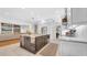 Bright kitchen featuring a large center island with barstool seating and custom cabinets for ample storage at 10101 Bryant Rd, Lithia, FL 33547