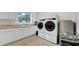 Well-equipped laundry room with modern washer, dryer, sink, and ample counter space at 10101 Bryant Rd, Lithia, FL 33547