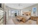 Bright main bedroom featuring a bay window, neutral tones, and natural wood furniture creating a relaxing retreat at 10101 Bryant Rd, Lithia, FL 33547
