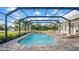 A stunning, screened-in pool with brick patio and sun loungers offer the perfect outdoor relaxation space at 10101 Bryant Rd, Lithia, FL 33547