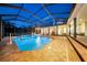 Inviting screened pool area with brick pavers, backyard views, and ample seating and entertaining space at 10101 Bryant Rd, Lithia, FL 33547