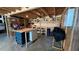 Functional work area with organized storage shelves, rolling tool table, and well-lit wooden ceilings at 10101 Bryant Rd, Lithia, FL 33547
