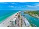 Scenic aerial view of a coastal community, showing the beach, buildings, boats, and a road running along the waterfront at 10215 Regal Dr # 41, Largo, FL 33774