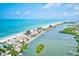 Coastal aerial shot showcasing beachfront properties, a canal, and a picturesque waterfront community on a sunny day at 10215 Regal Dr # 41, Largo, FL 33774