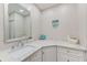 Modern bathroom featuring a sleek vanity with marble countertop and a stylish mirror at 10215 Regal Dr # 41, Largo, FL 33774