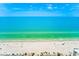 Expansive beach view showing white sand, turquoise water, and scattered beachgoers enjoying a sunny day at 10215 Regal Dr # 41, Largo, FL 33774