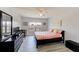 Cozy bedroom with neutral walls, wood-look floors, ceiling fan, and bright natural lighting at 10215 Regal Dr # 41, Largo, FL 33774