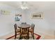 Cozy dining area with dark wood table and chairs, tile flooring, and bright white walls at 10215 Regal Dr # 41, Largo, FL 33774
