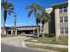 Exterior of building, showing multiple parking garages and palm trees at 10215 Regal Dr # 41, Largo, FL 33774