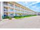 Exterior of a condominium building featuring well-maintained balconies and lawn at 10215 Regal Dr # 41, Largo, FL 33774
