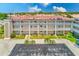 Multi-story condo complex with balconies, neatly manicured landscaping, and a tiled roof at 10215 Regal Dr # 41, Largo, FL 33774