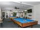 Spacious game room with pool tables, flat screen TV, and ceiling fans at 10215 Regal Dr # 41, Largo, FL 33774