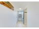 Well lit hallway with coat rack and beach decor leading to the front door and open doorway at 10215 Regal Dr # 41, Largo, FL 33774