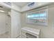 Breakfast nook with large window offering outside view, storage closet, and access to kitchen at 10215 Regal Dr # 41, Largo, FL 33774