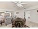 Bright living room featuring a ceiling fan, a sliding glass door to the balcony and comfortable seating at 10215 Regal Dr # 41, Largo, FL 33774