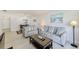 Comfortable living room showcasing tile flooring, neutral-toned furniture, and an open floorplan at 10215 Regal Dr # 41, Largo, FL 33774