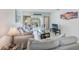 Inviting living room featuring comfortable seating, a glass coffee table, and natural lighting at 10215 Regal Dr # 41, Largo, FL 33774
