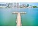 Waterfront view featuring a long pier extending into the serene water, with buildings in the background, under a clear sky at 10215 Regal Dr # 41, Largo, FL 33774