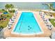 Beautiful pool with plenty of seating and umbrellas for shade on a brick pool deck at 10215 Regal Dr # 41, Largo, FL 33774