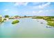 Scenic waterfront community showcasing canals, docks, waterfront homes, and lush greenery, under a partly cloudy sky at 10215 Regal Dr # 41, Largo, FL 33774