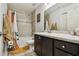 Bright bathroom featuring vanity with drawers, tiled tub, and modern finishes at 105 Blue Alice Spring Ct, Ruskin, FL 33570