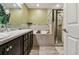 Bathroom featuring dual sinks, a soaking tub and a walk-in shower at 105 Blue Alice Spring Ct, Ruskin, FL 33570