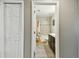 View of tiled bathtub and vanity through open door, adding depth to the space at 105 Blue Alice Spring Ct, Ruskin, FL 33570