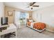 Cozy bedroom with a ceiling fan, desk and a large window for natural light at 105 Blue Alice Spring Ct, Ruskin, FL 33570